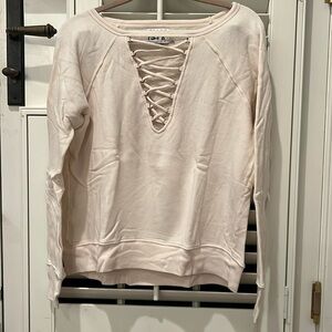 Pam & Gela cream crewneck sweatshirt with v neck lace up detail